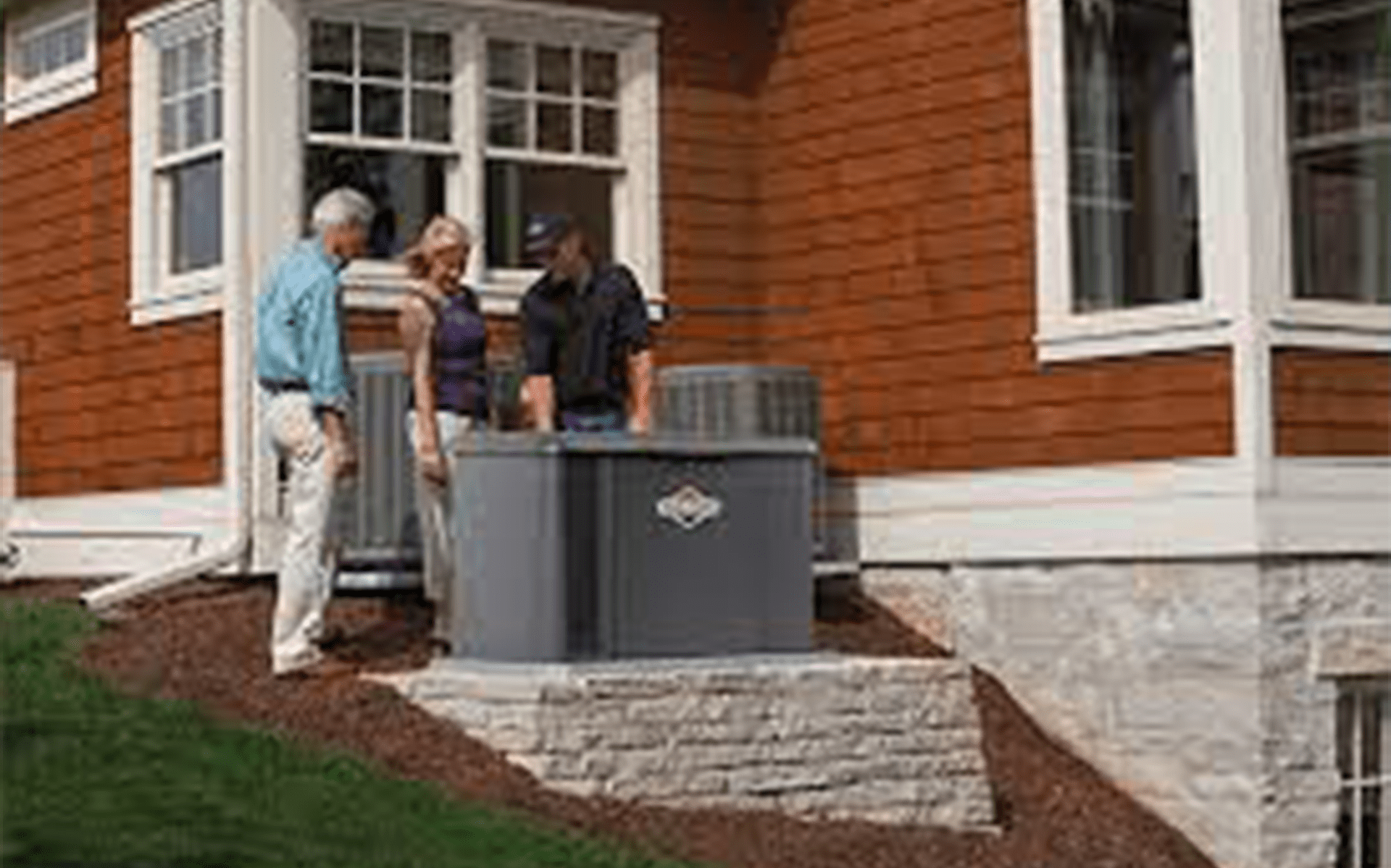 Three people inspecting the generator